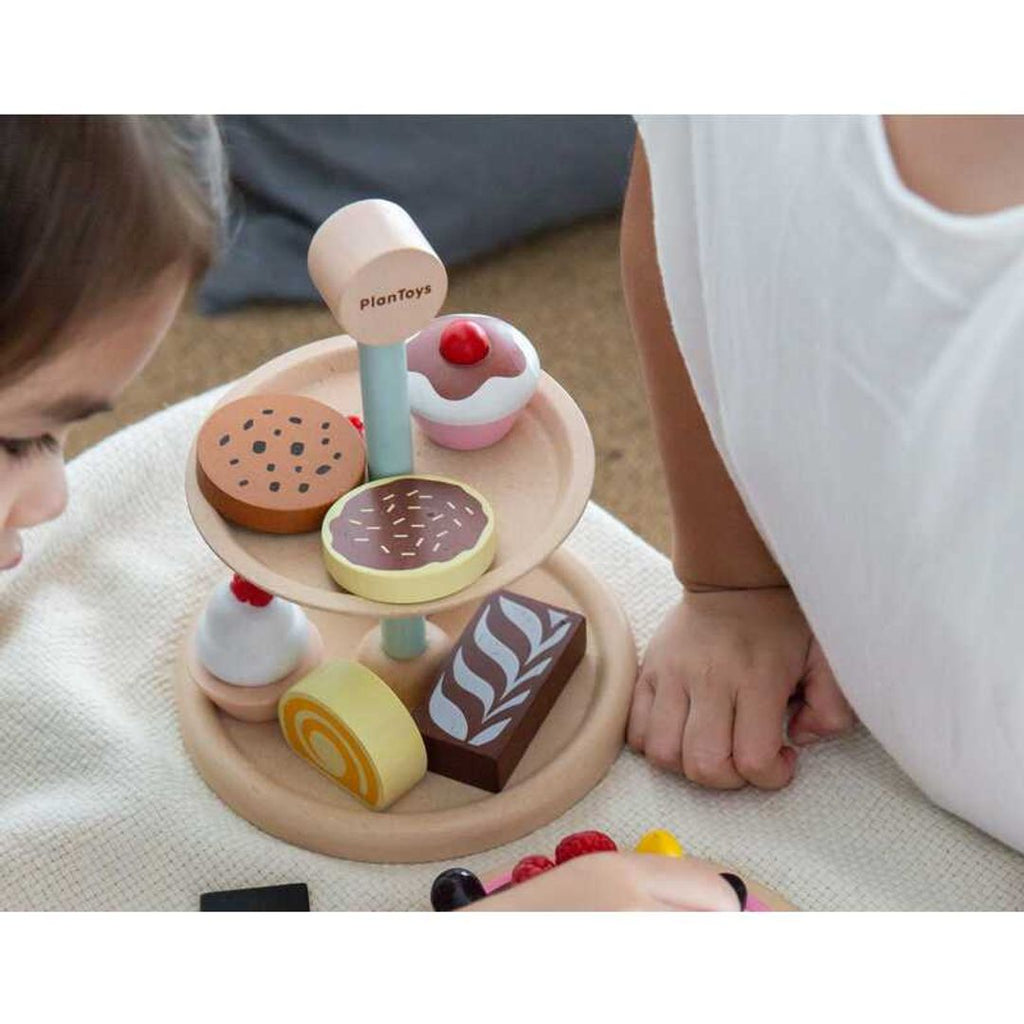 Kid playing PlanToys Bakery Stand Set