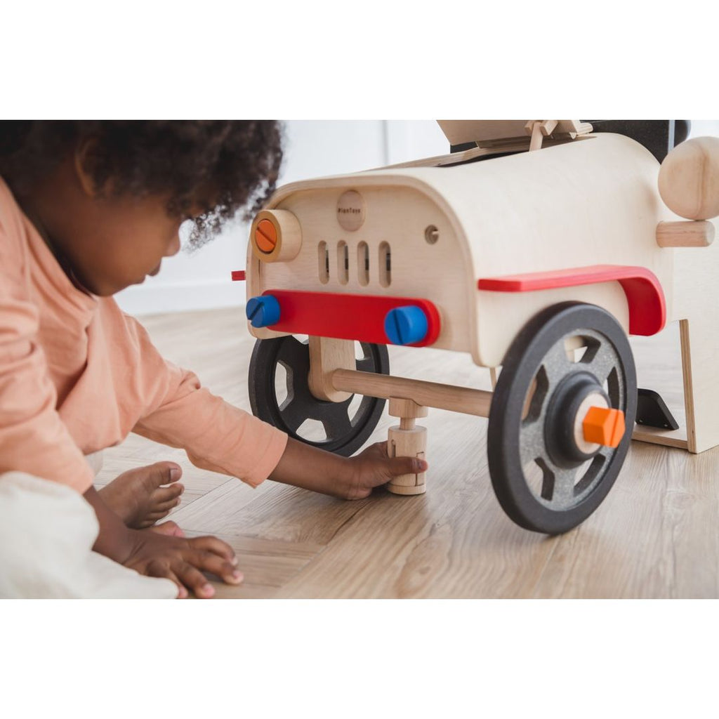 Kid playing PlanToys Motor Mechanic