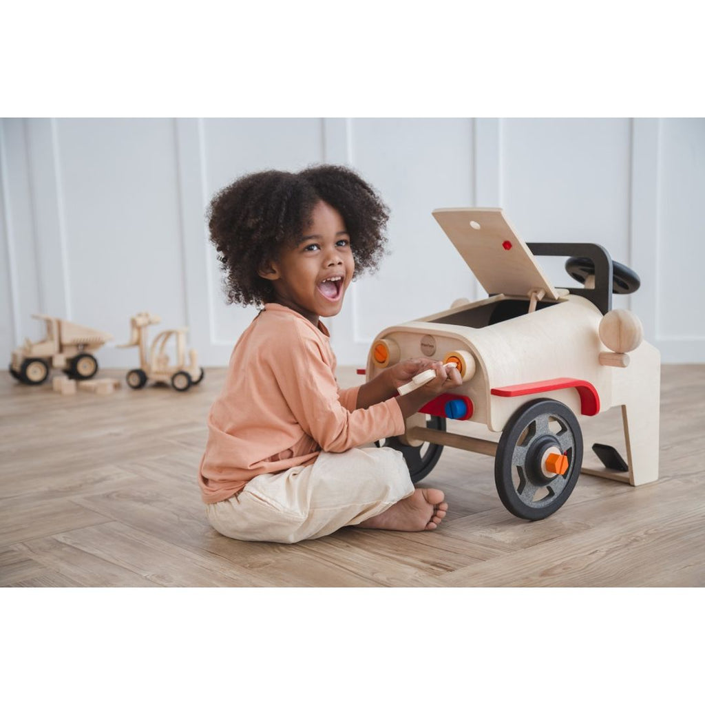 Kid playing PlanToys Motor Mechanic