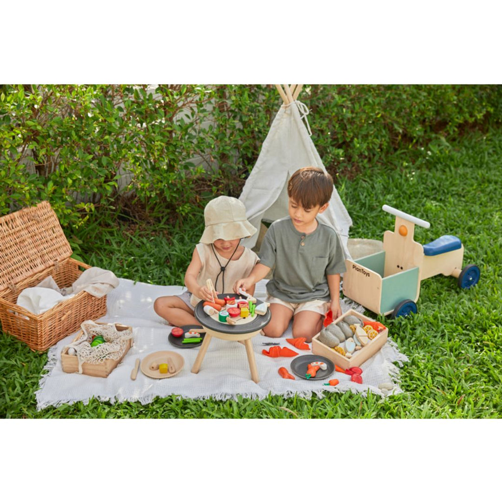 Kid playing PlanToys Bbq Playset