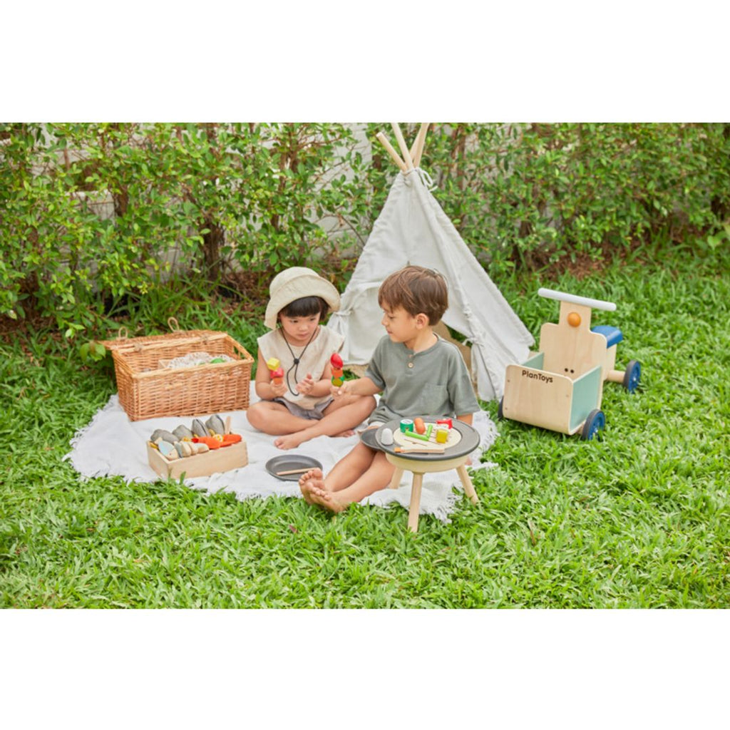 Kid playing PlanToys Bbq Playset