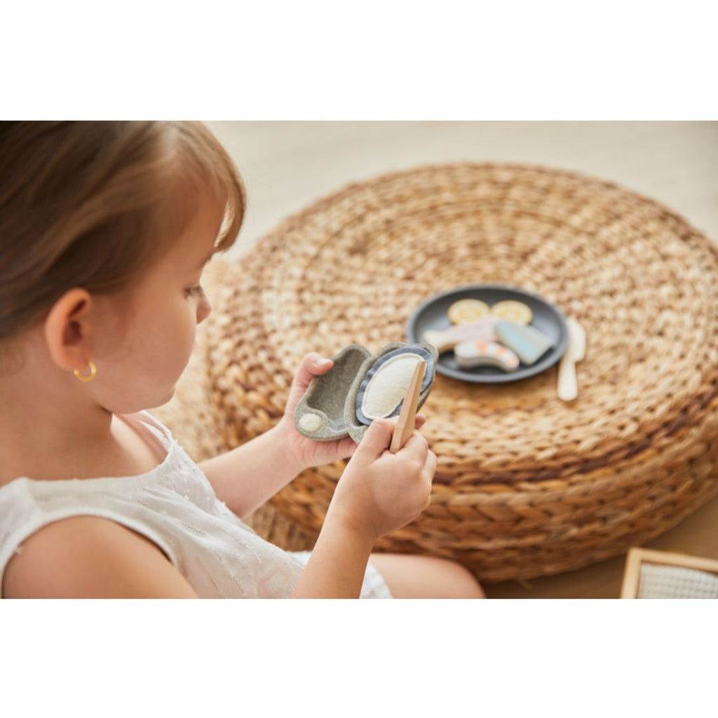 Kid playing PlanToys Seafood Platter