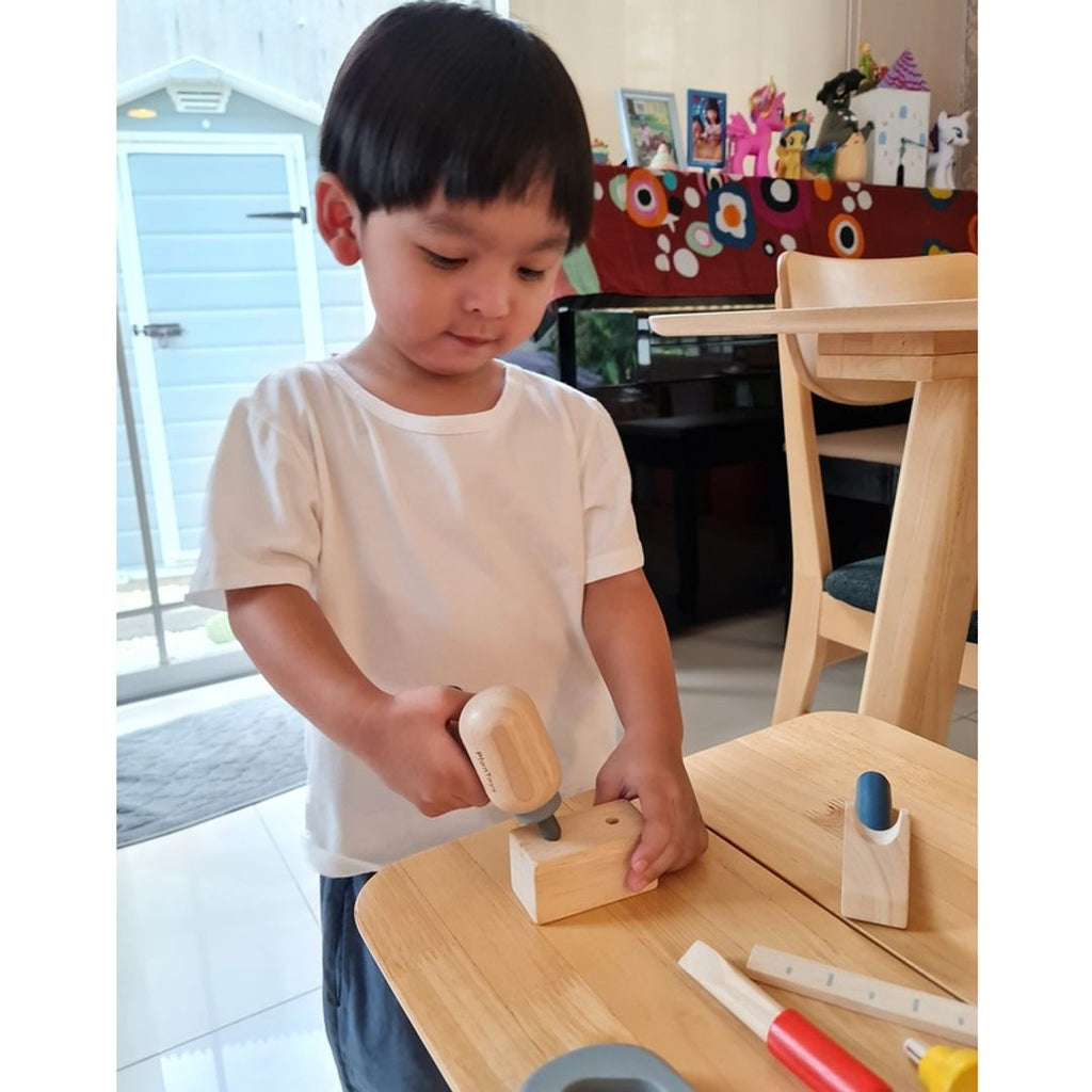 Kid playing PlanToys Handy Carpenter Set