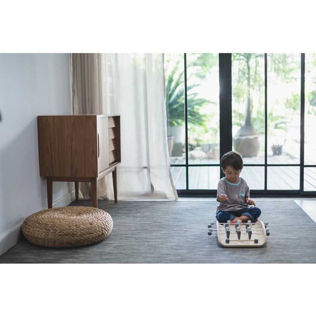 Kid playing PlanToys Soccer