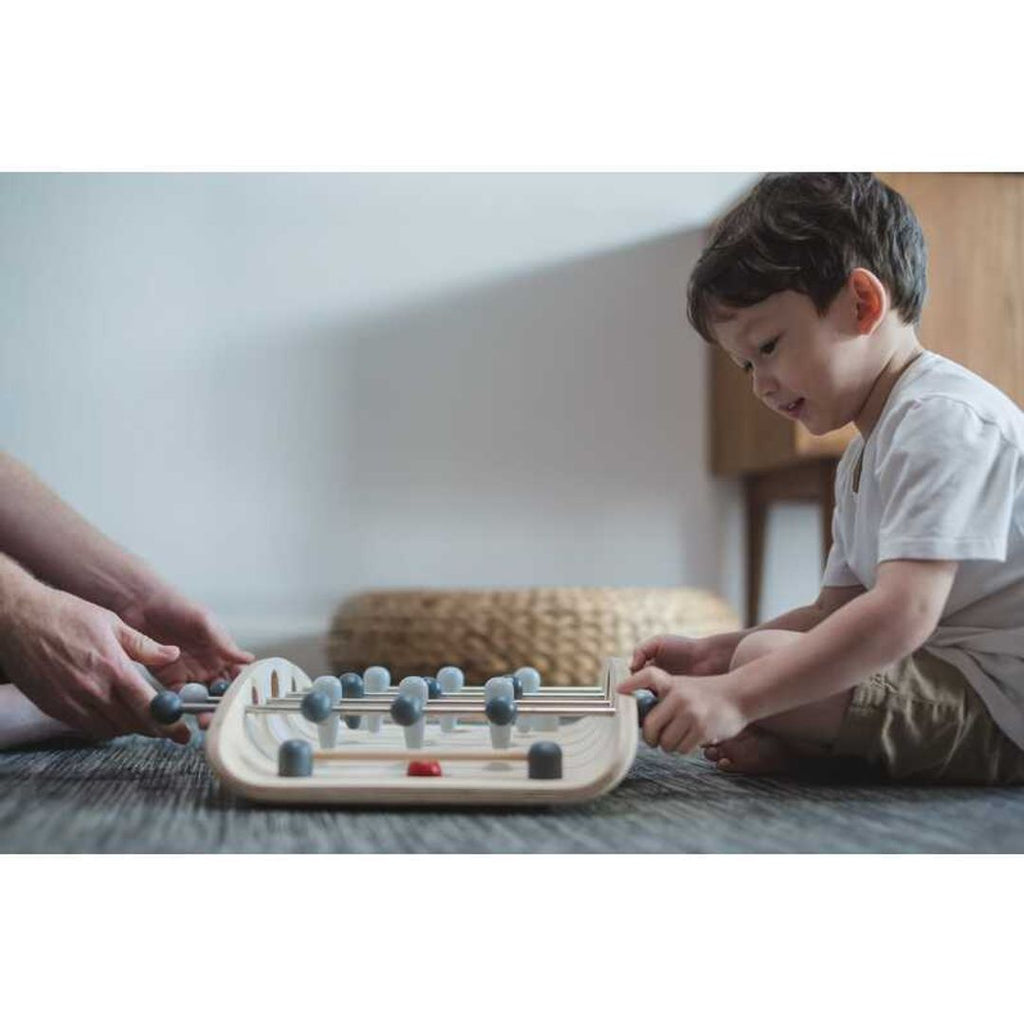 Kid playing PlanToys Soccer