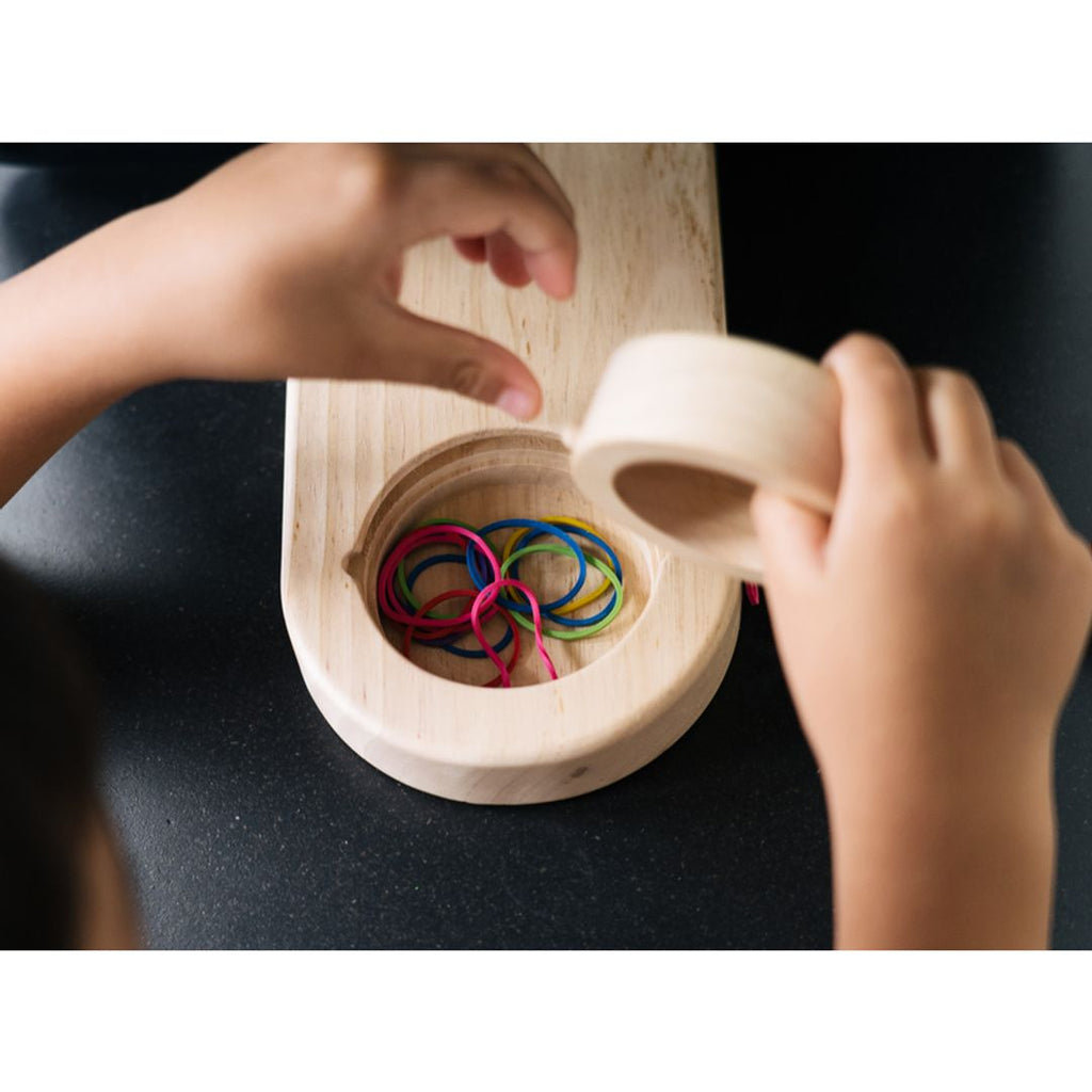 Kid playing PlanToys Wall Ball Game