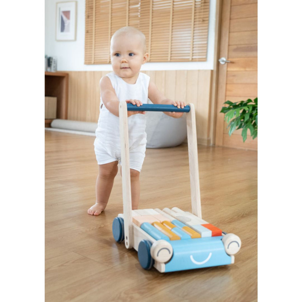 Kid playing PlanToys Baby Walker - Orchard