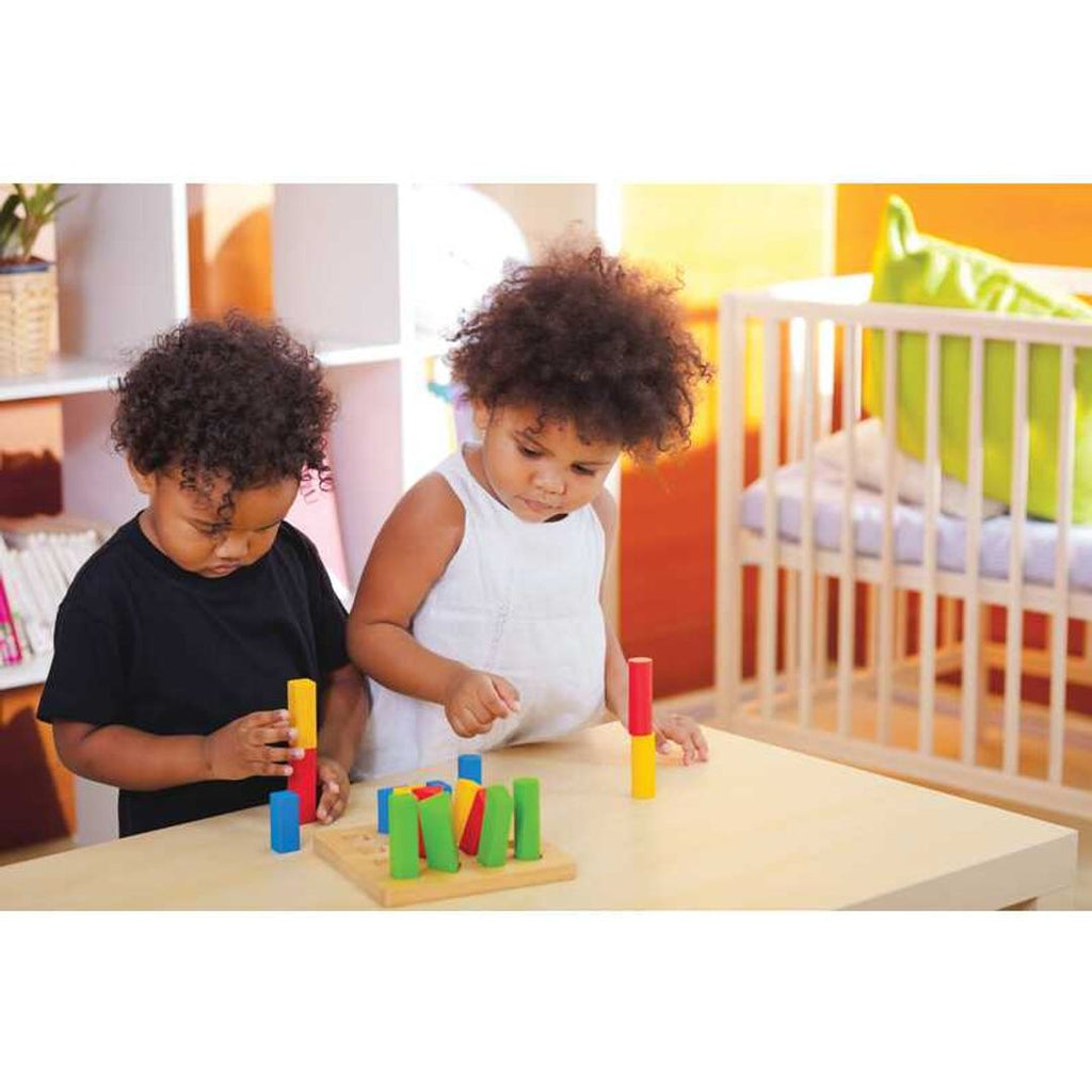 Kid playing PlanToys Geometric Peg Board