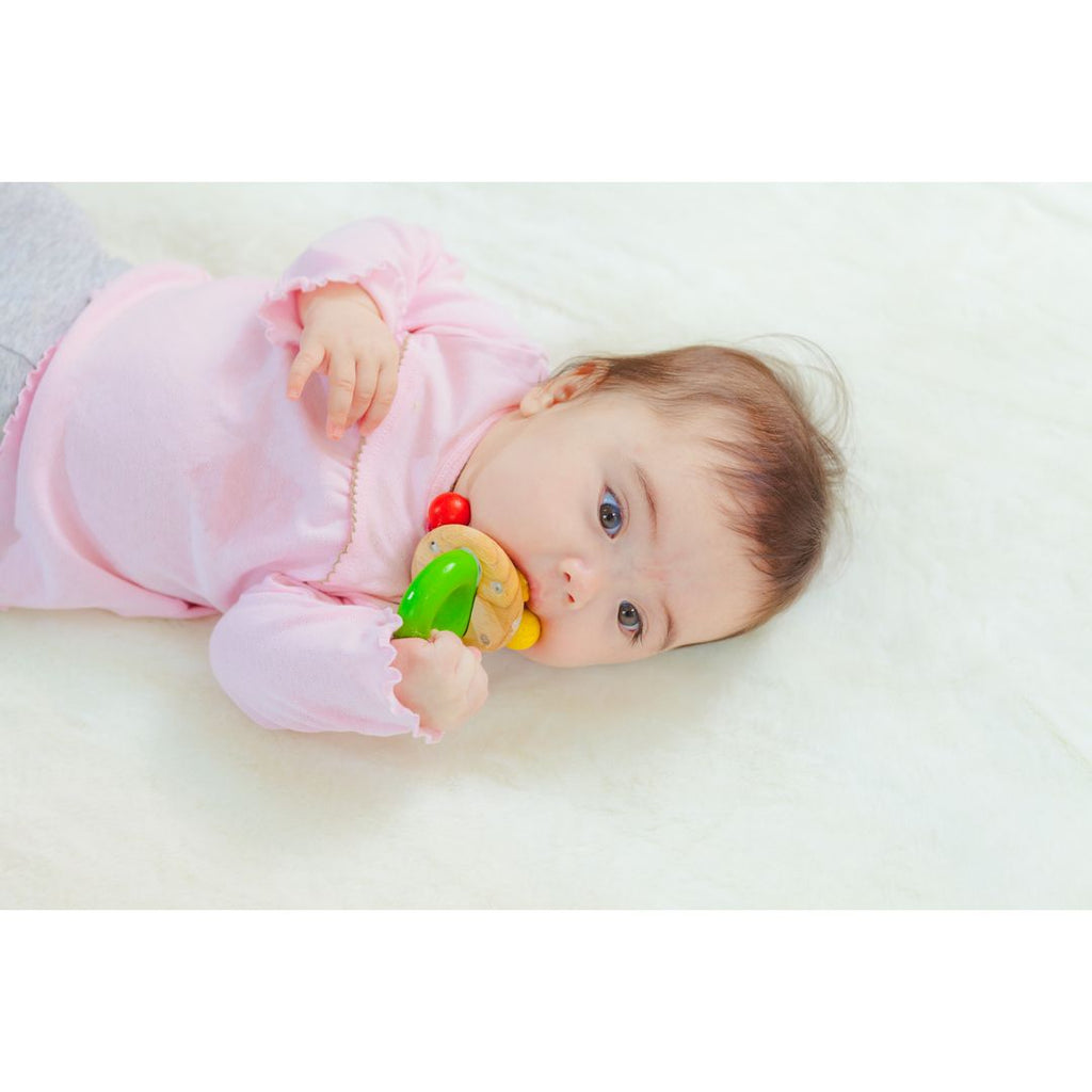 Kid playing PlanToys Bell Rattle