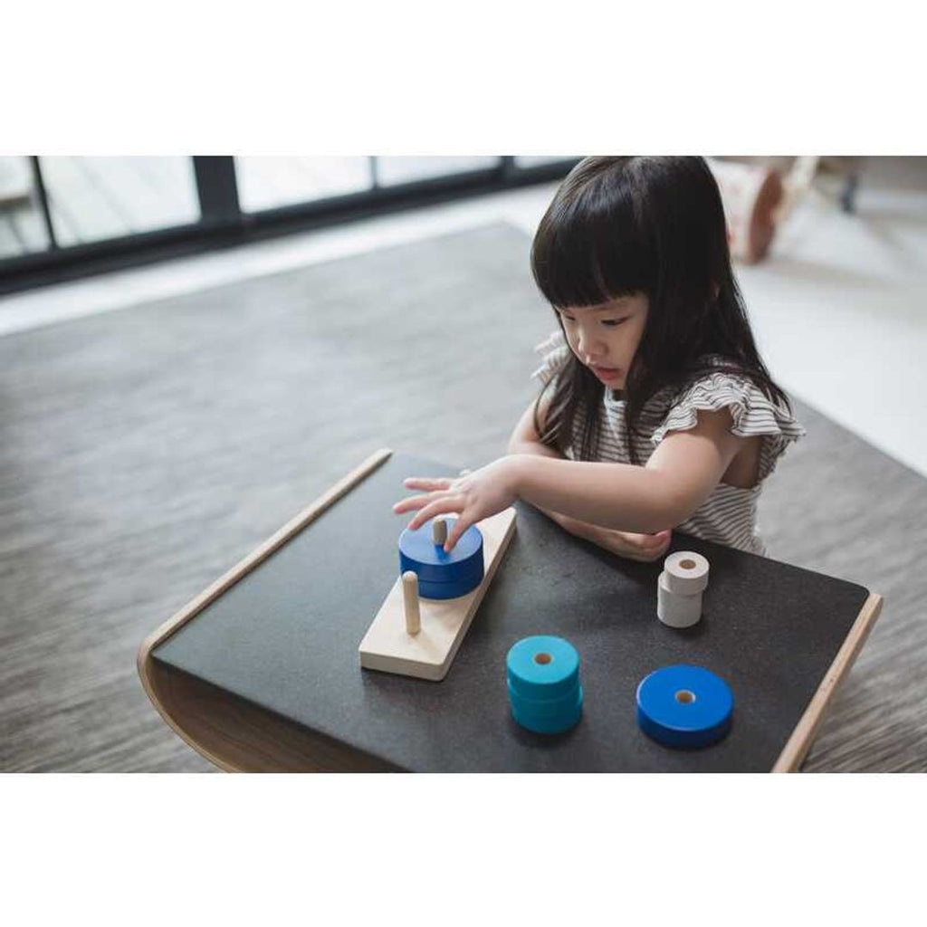 Kid playing PlanToys Trio Stacking