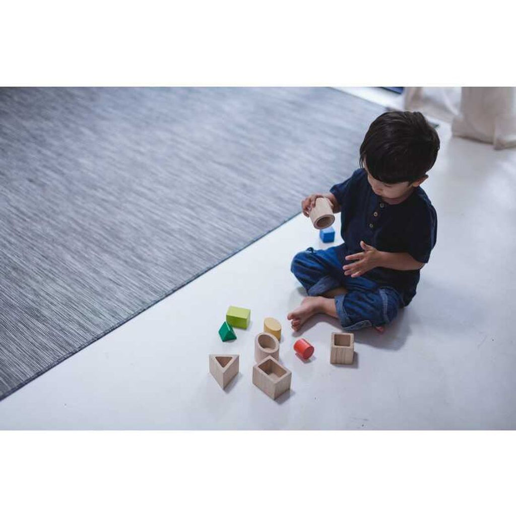 Kid playing PlanToys Geo Matching Blocks