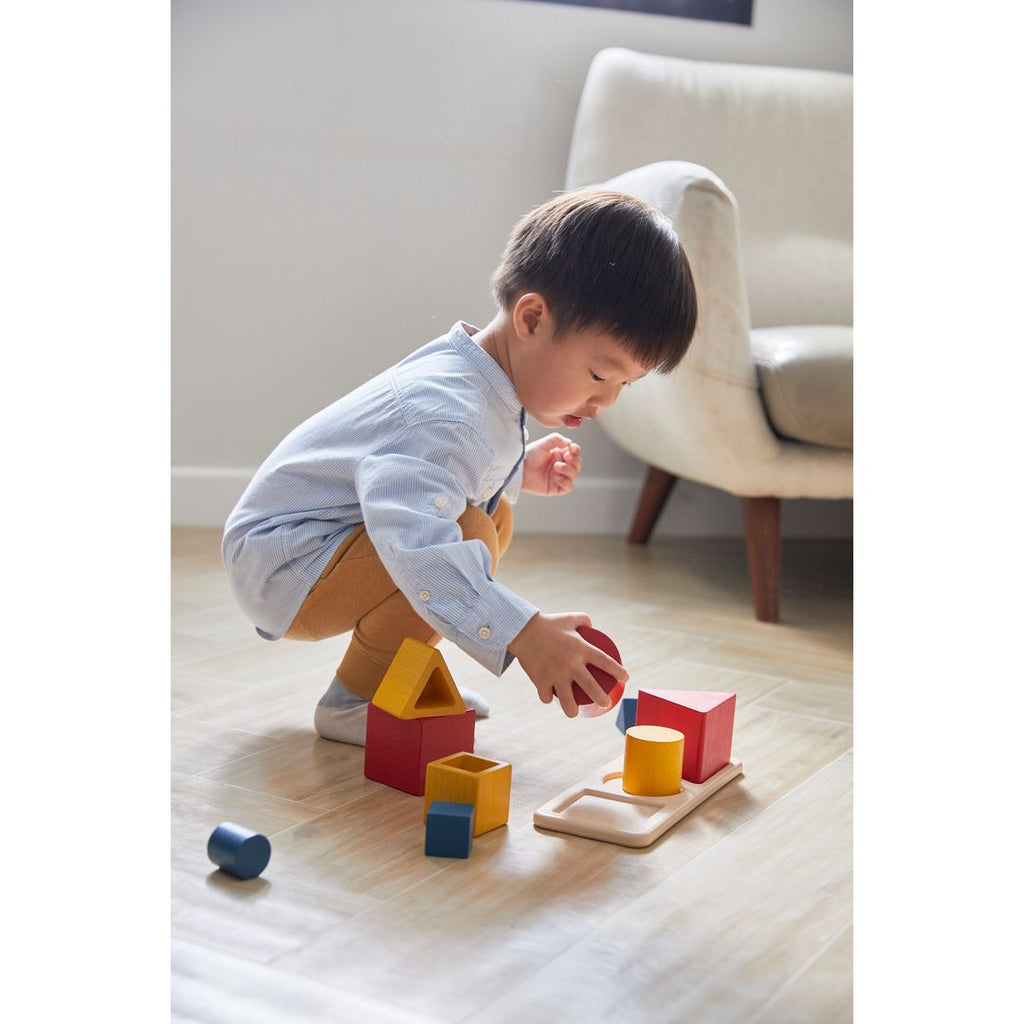 Kid playing PlanToys Nesting Puzzle - Unit Plus