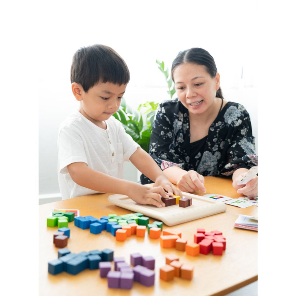 Kid playing PlanToys 100 Counting Cubes - Unit Plus