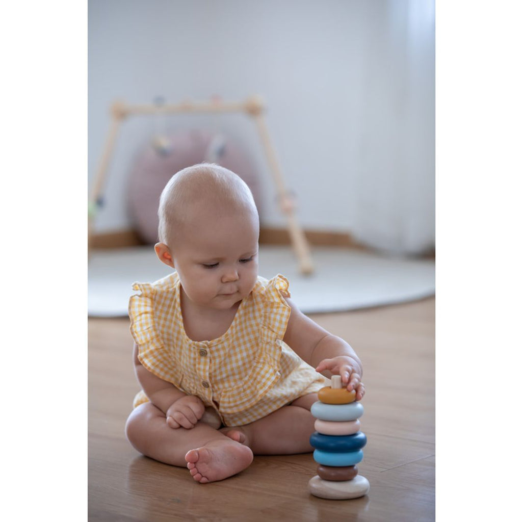 Kid playing PlanToys Stacking Ring - Orchard