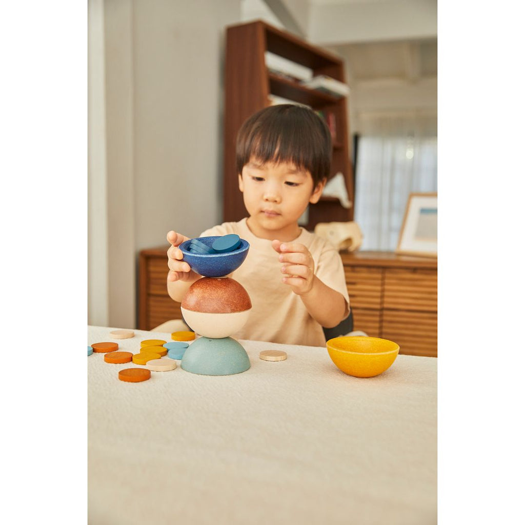 Kid playing PlanToys Sort & Count Cups - Orchard 