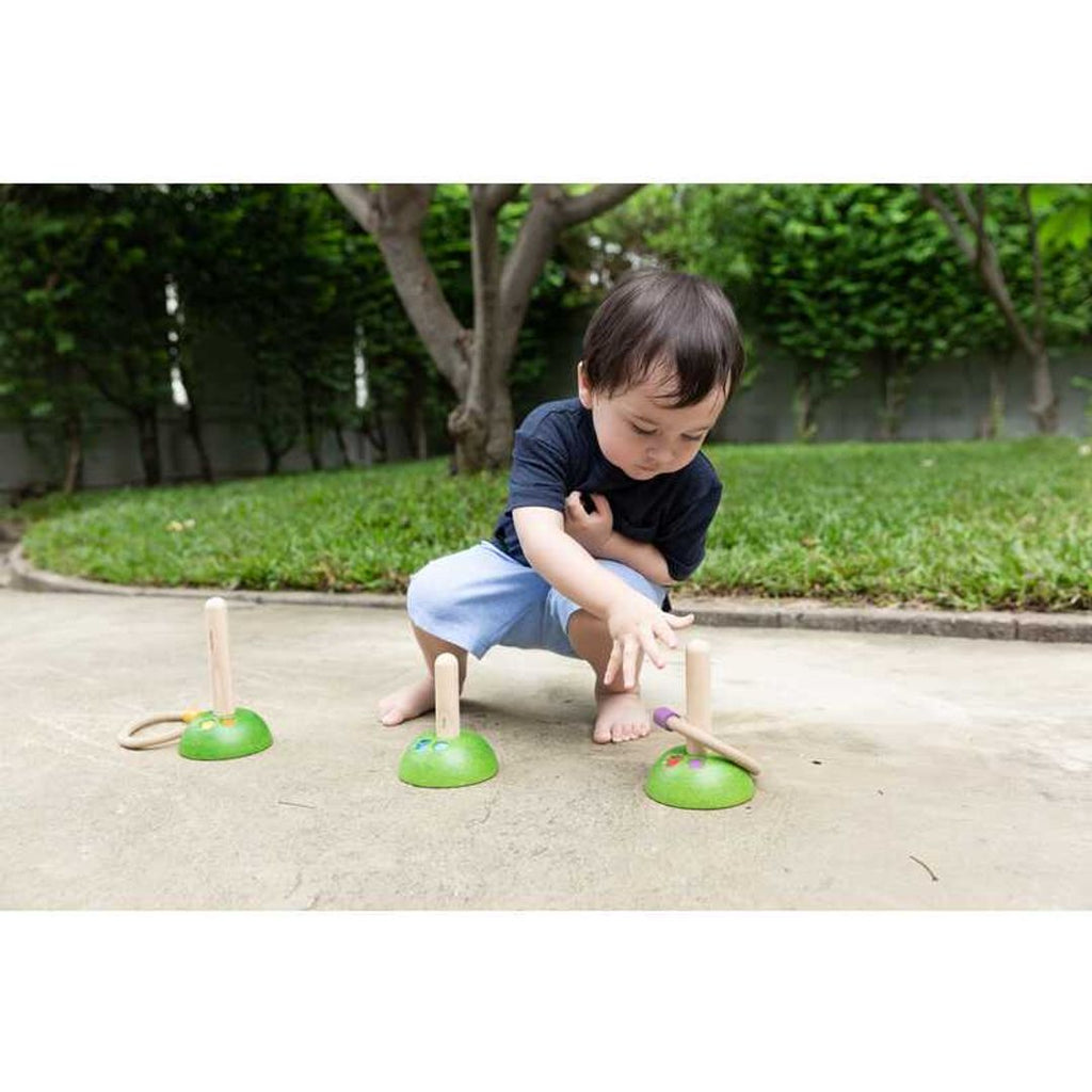 Kid playing PlanToys Meadow Ring Toss