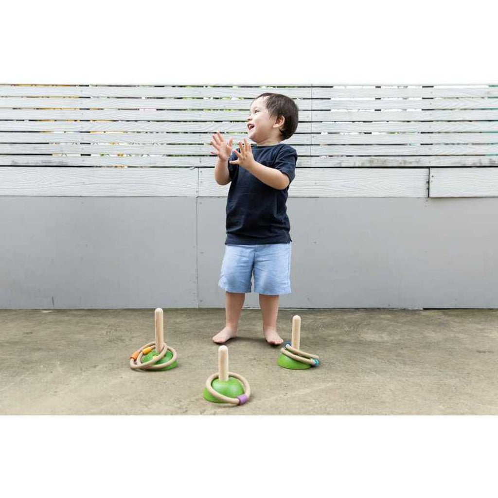 Kid playing PlanToys Meadow Ring Toss