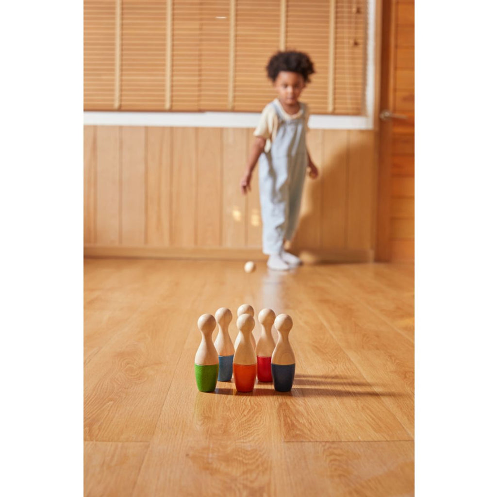 Kid playing PlanToys Bowling Set