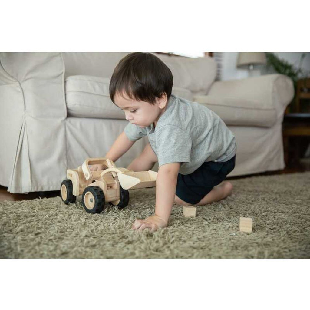 Kid playing PlanToys Bulldozer