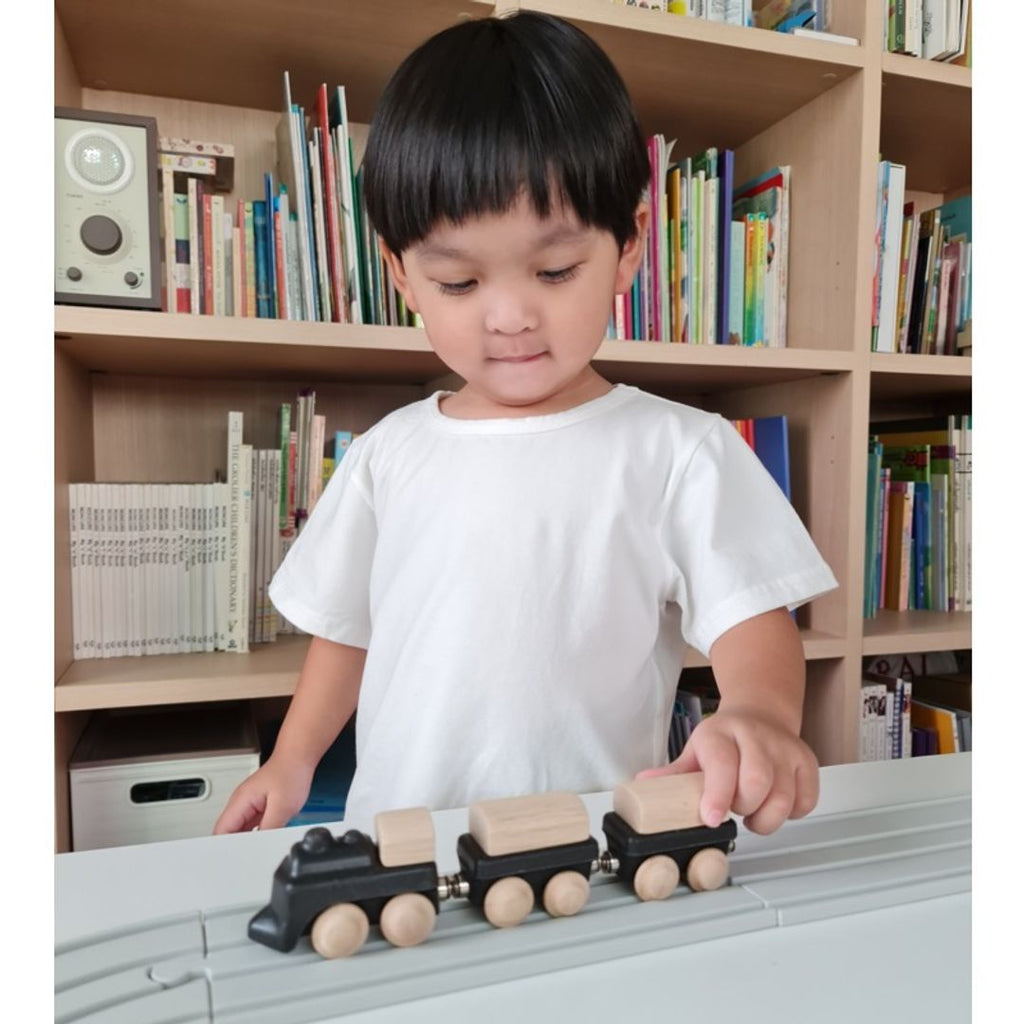 Kid playing PlanToys Classic Train