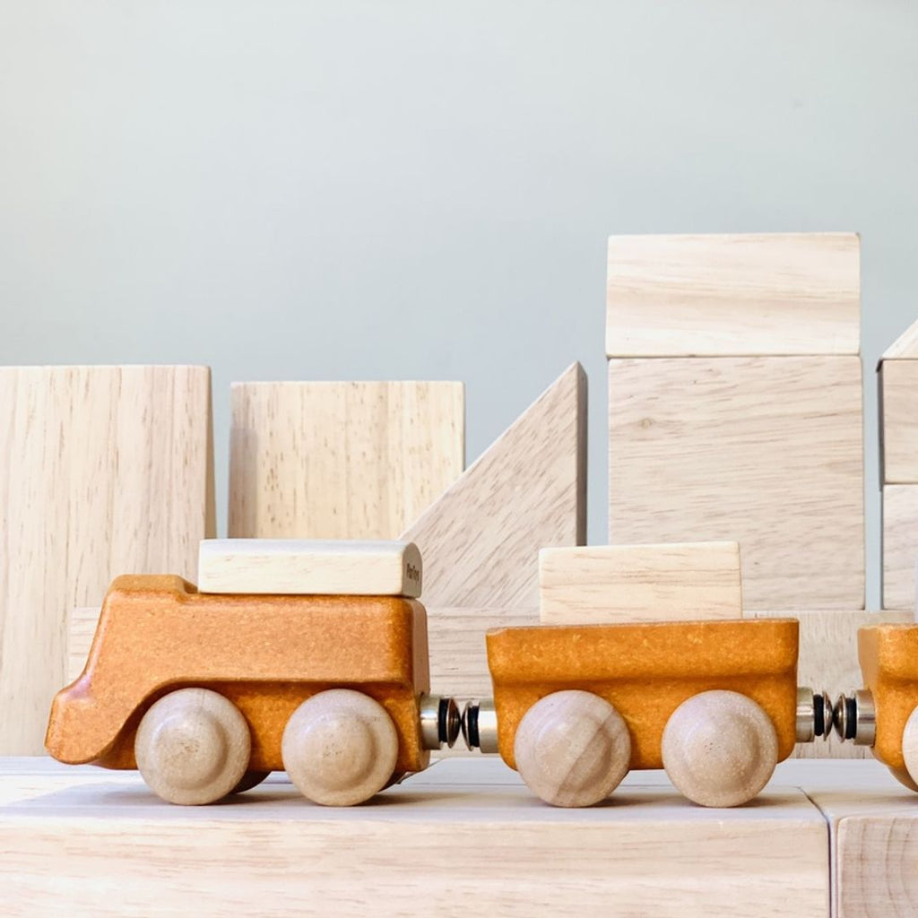 Kid playing PlanToys Cargo Train