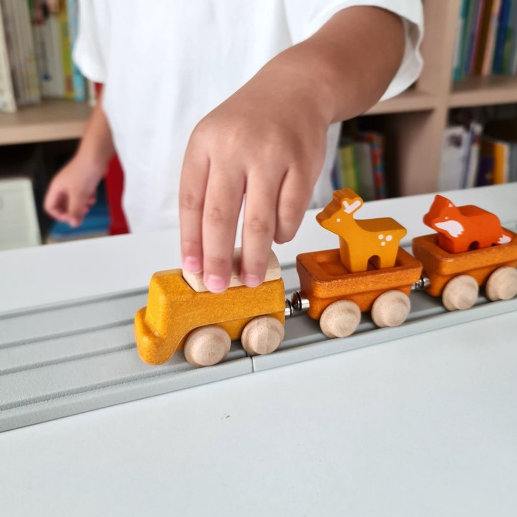 Kid playing PlanToys Cargo Train