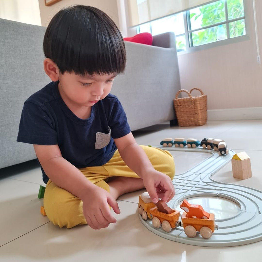 Kid playing PlanToys Cargo Train