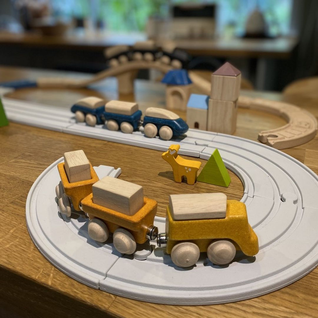 Kid playing PlanToys Cargo Train