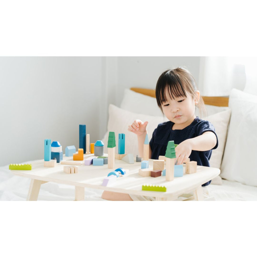 Kid playing PlanToys Urban City Blocks