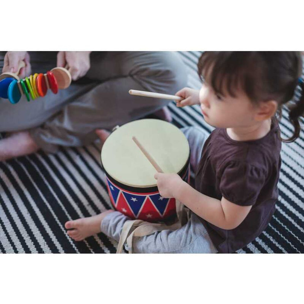 Kid playing PlanToys Big Drum II