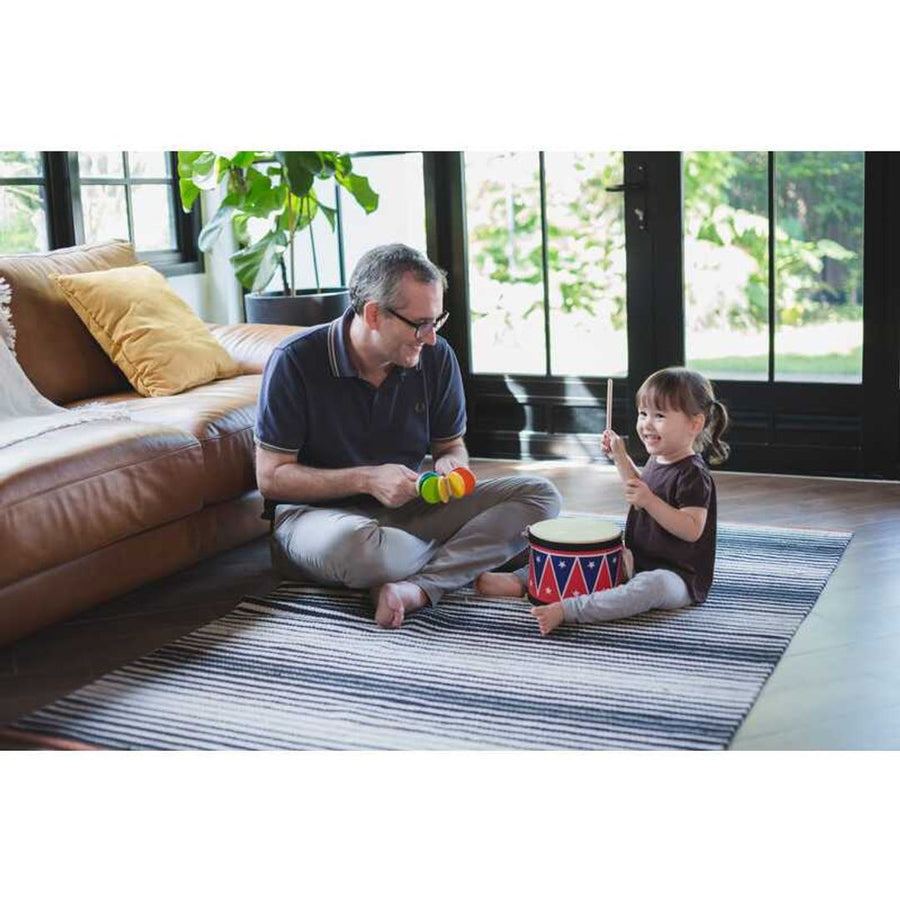 Kid playing PlanToys Big Drum II