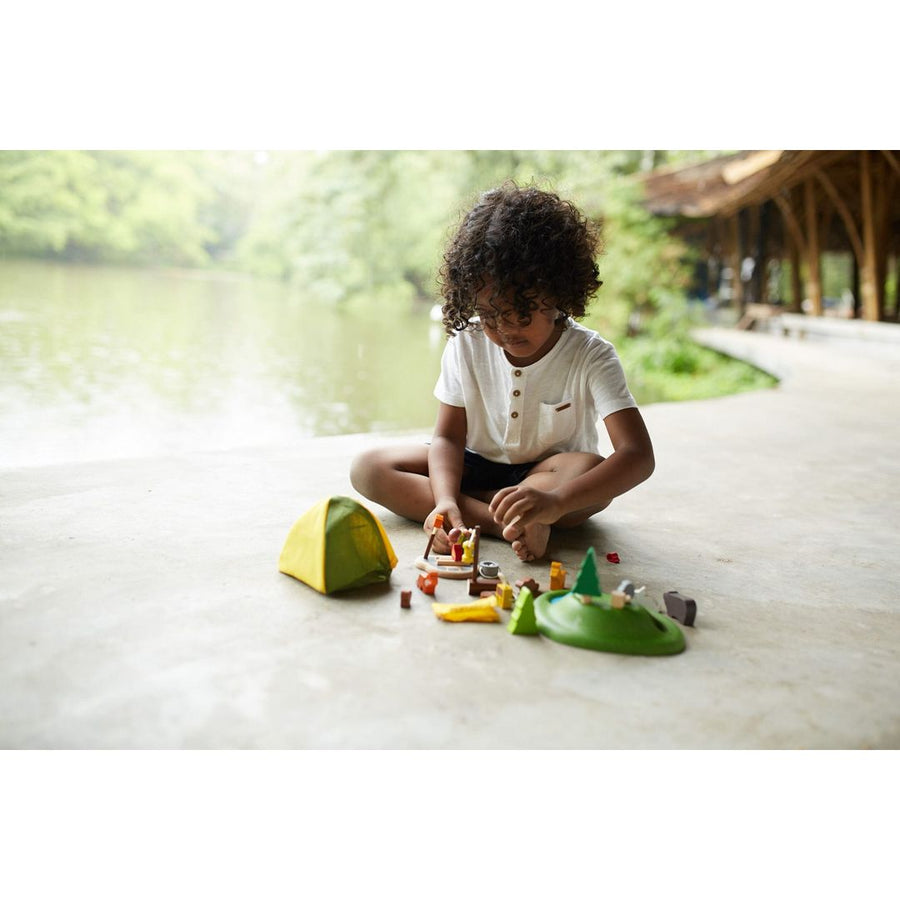 Kid playing PlanToys Camping Set