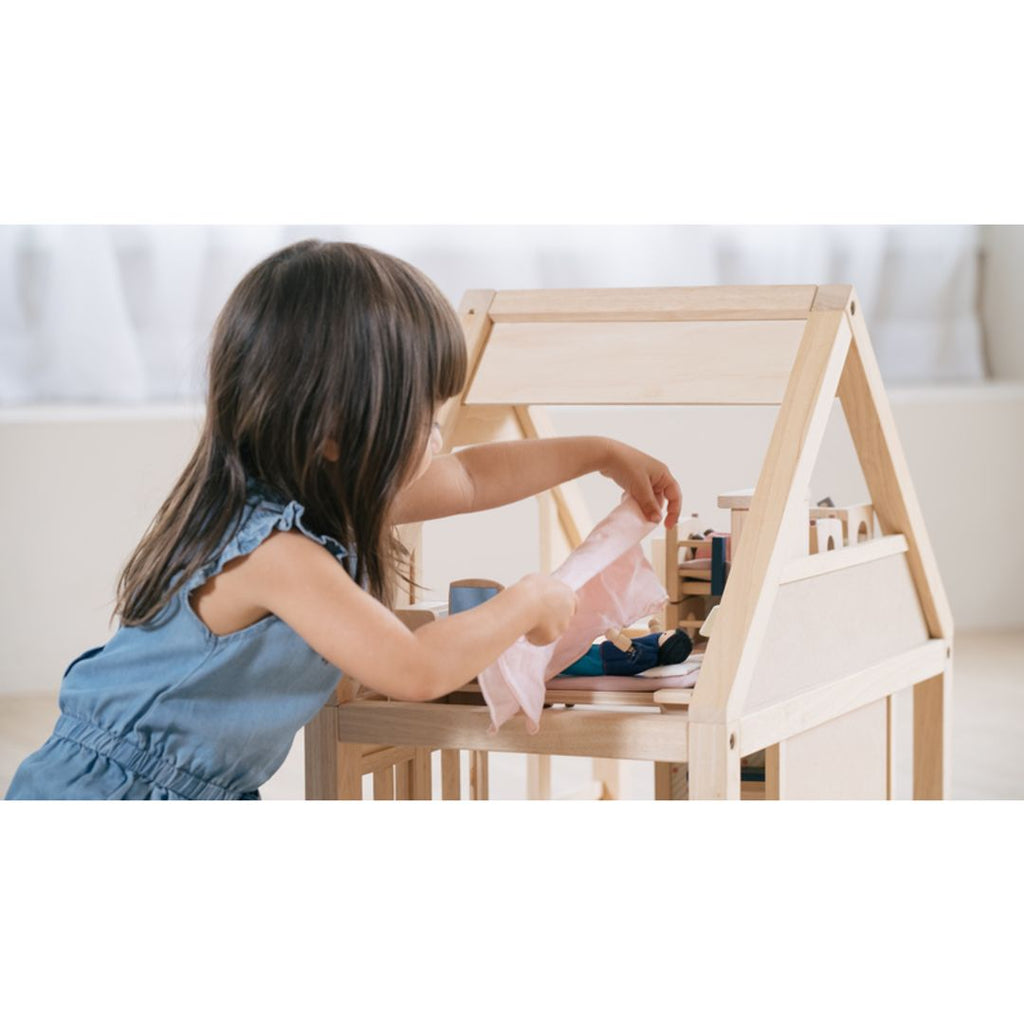 Kid playing PlanToys My First Dollhouse