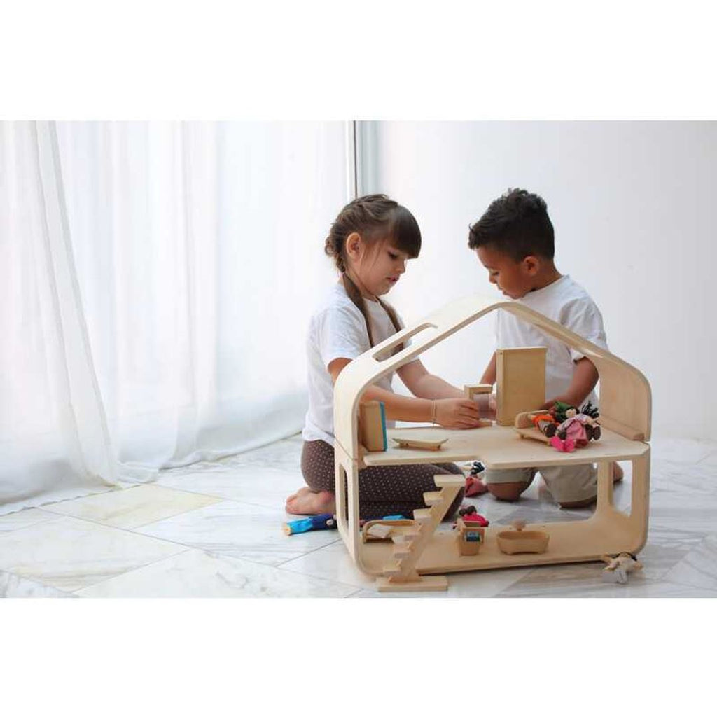 Kid playing PlanToys Contemporary Dollhouse