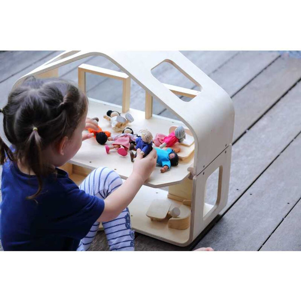 Kid playing PlanToys Contemporary Dollhouse