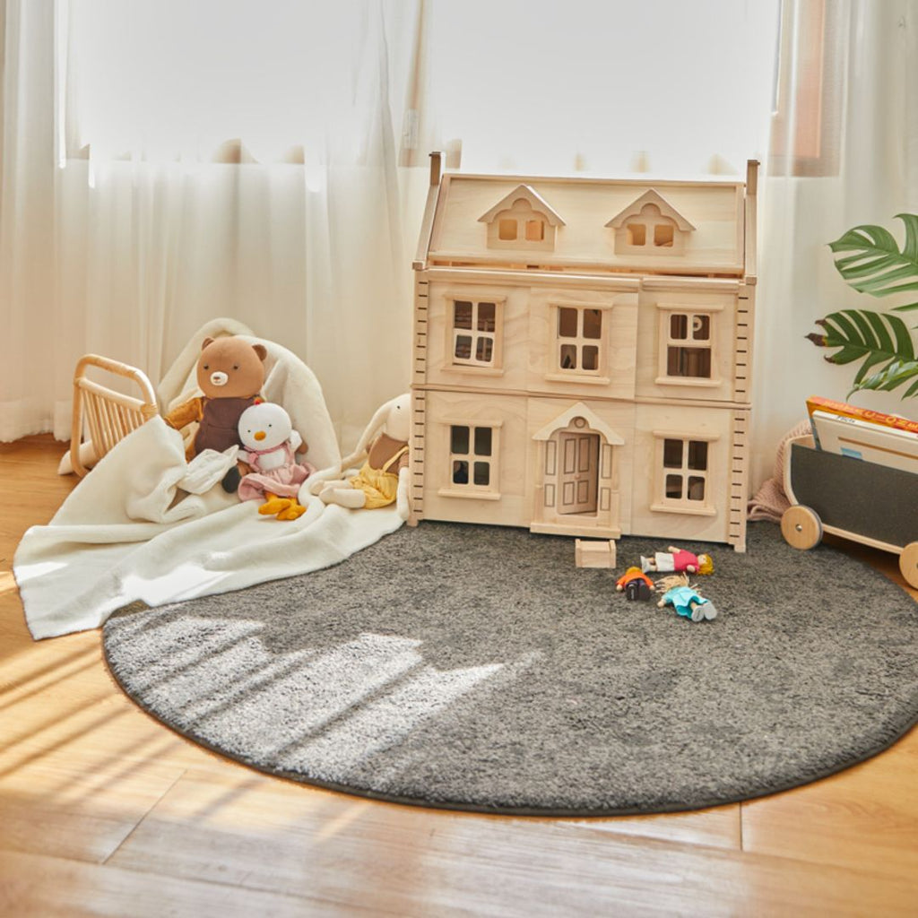 Kid playing PlanToys Victorian Dollhouse