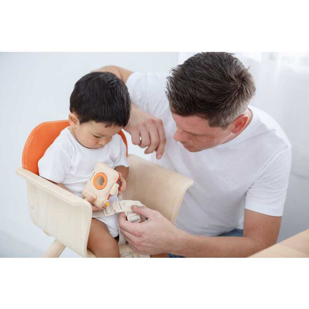 Kid using PlanToys High Chair - Orange