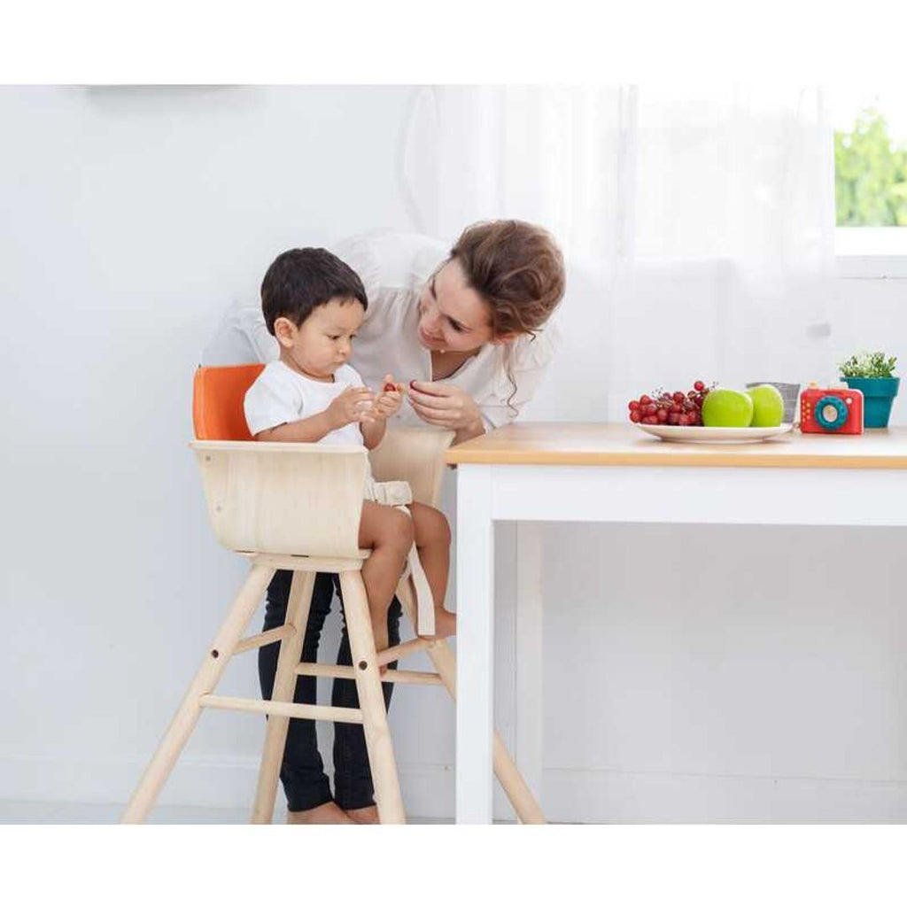 Kid using PlanToys High Chair - Orange